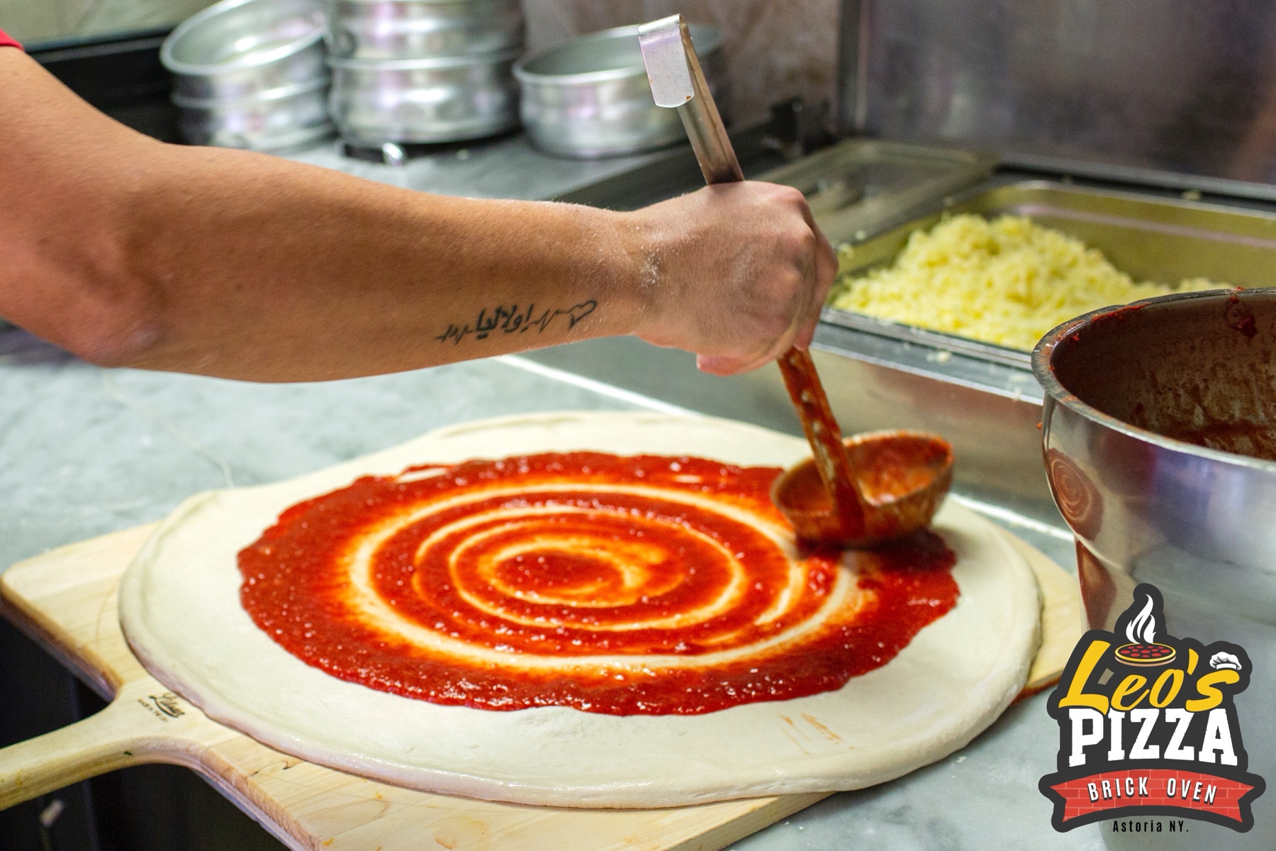 Pizza dough being sauced at Leo's Pizza